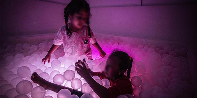 Two little girls in a ball pit